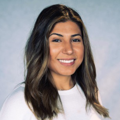 Headshot of Kimberly Jeane in white shirt on light blue background